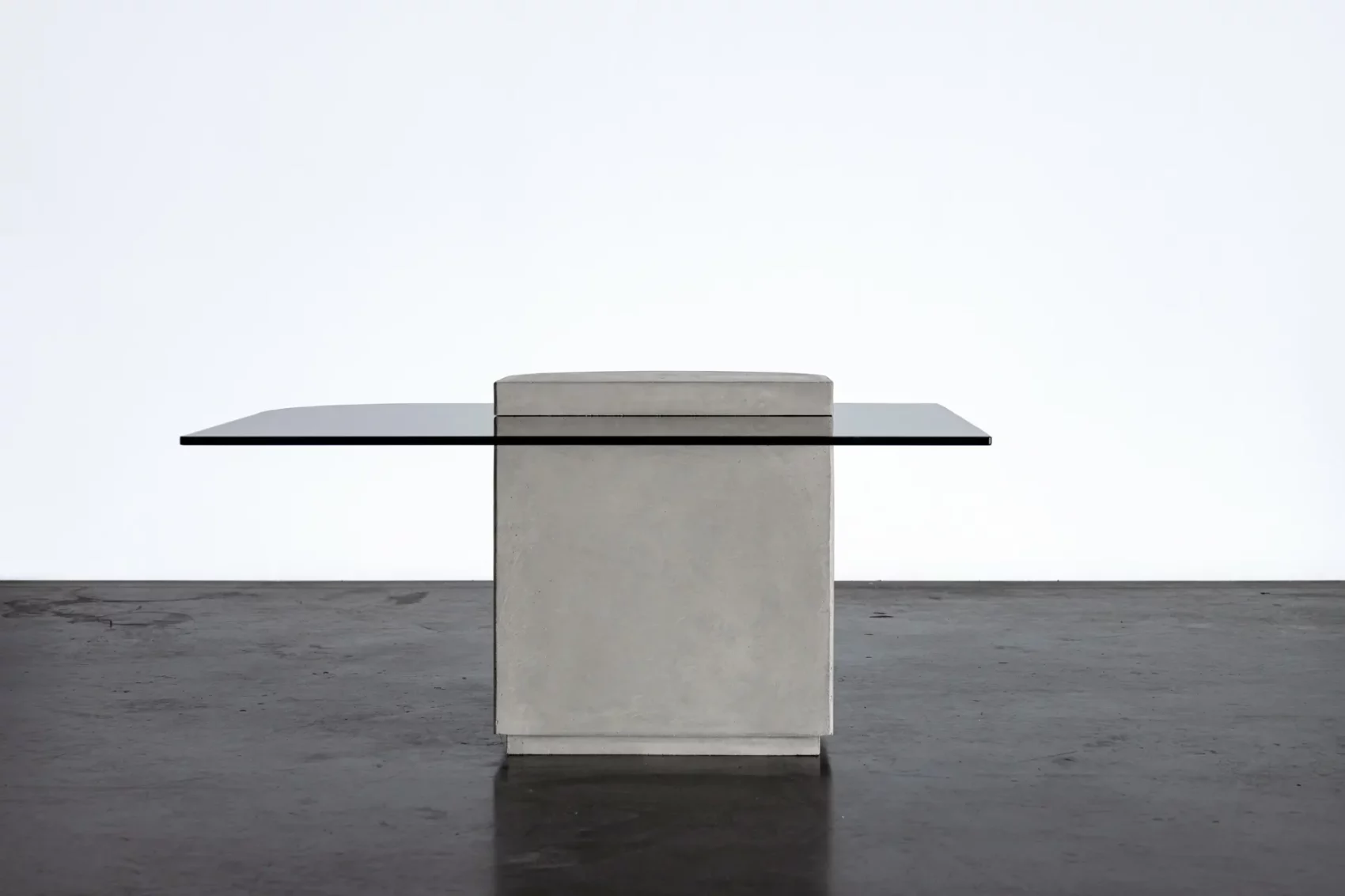 Concrete and hybrid glass cabinet between a coffee table and an extra table