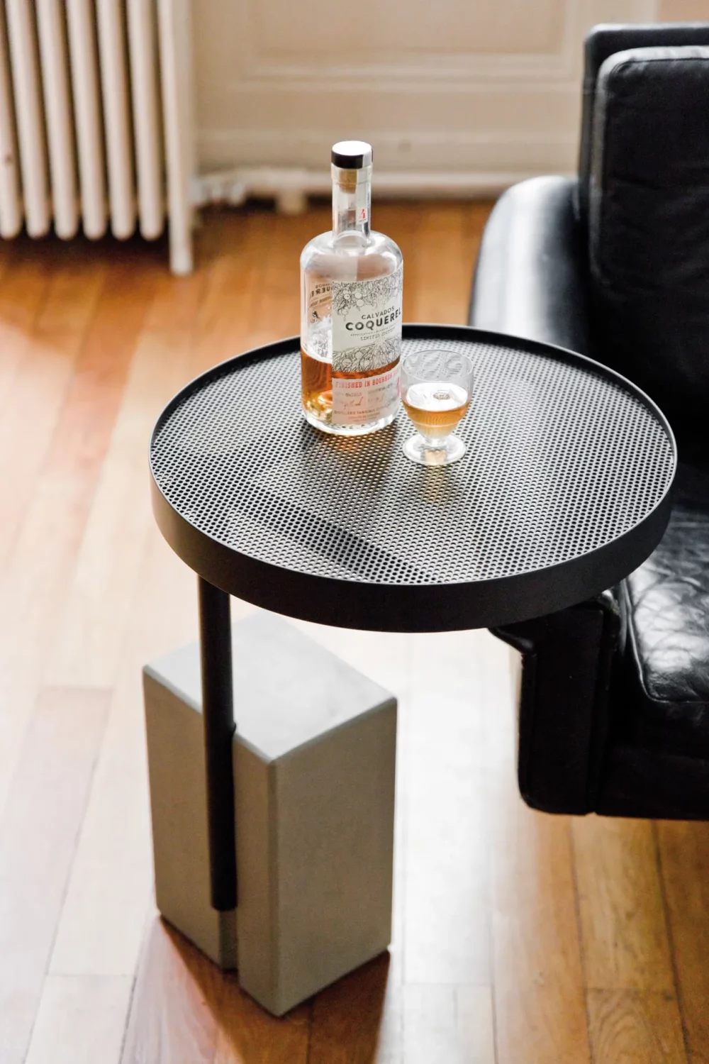 A glimpse of the perforated steel top that reveals the concrete ballast of the Twist pedestal table