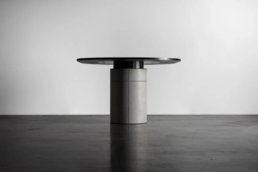 Detail of the wooden tinted matt black oak tabletop of the Sharp concrete dining table by Bertrand Jayr