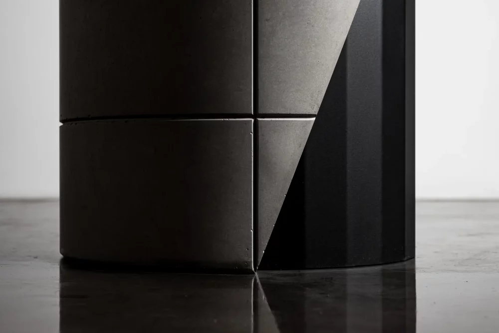 Brutalist detail of the concrete shell which covers the metal foot of the Sharp dining table by designer Bertrand Jayr