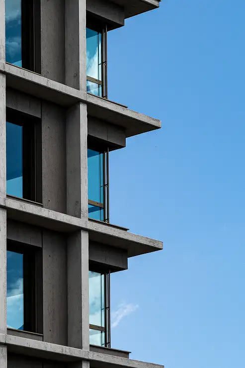 Brutalist building facade in raw concrete, 1960s architecture