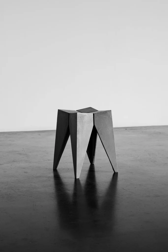 Concrete Bridge stool on a polished concrete floor, black and white photo.