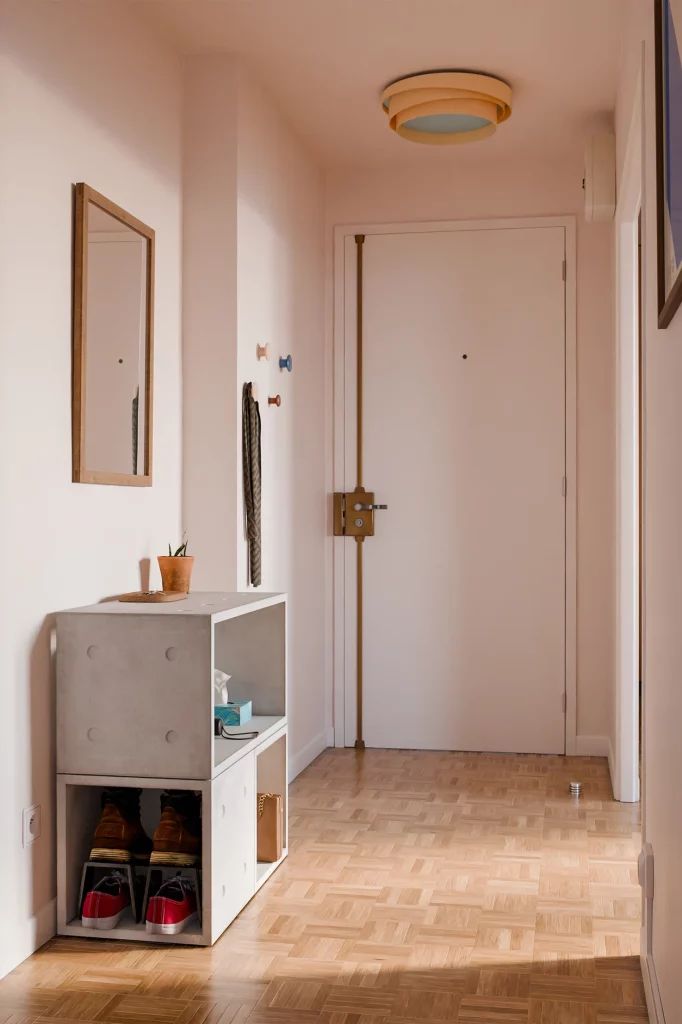 Concrete Dice modules used as an entryway unit, with shoes below and a plant on top.