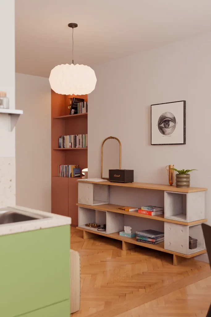 Low unit made of concrete Dice modules and oak boards, with books and a speaker.